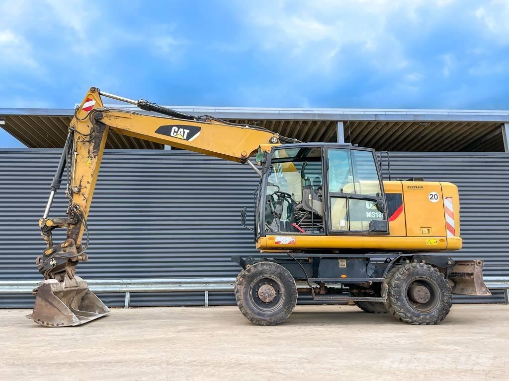 CAT M318F Gumikerekes kotrók
