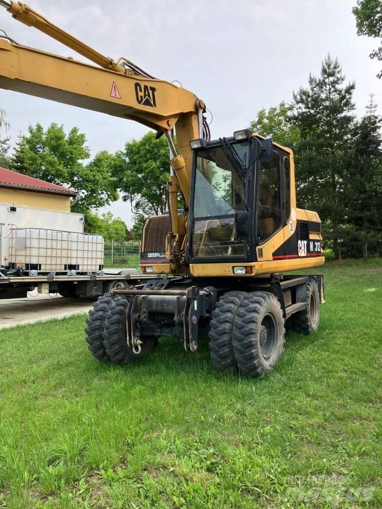 CAT M 312 Gumikerekes kotrók
