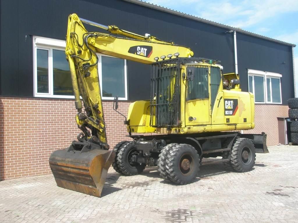 CAT M318F Gumikerekes kotrók