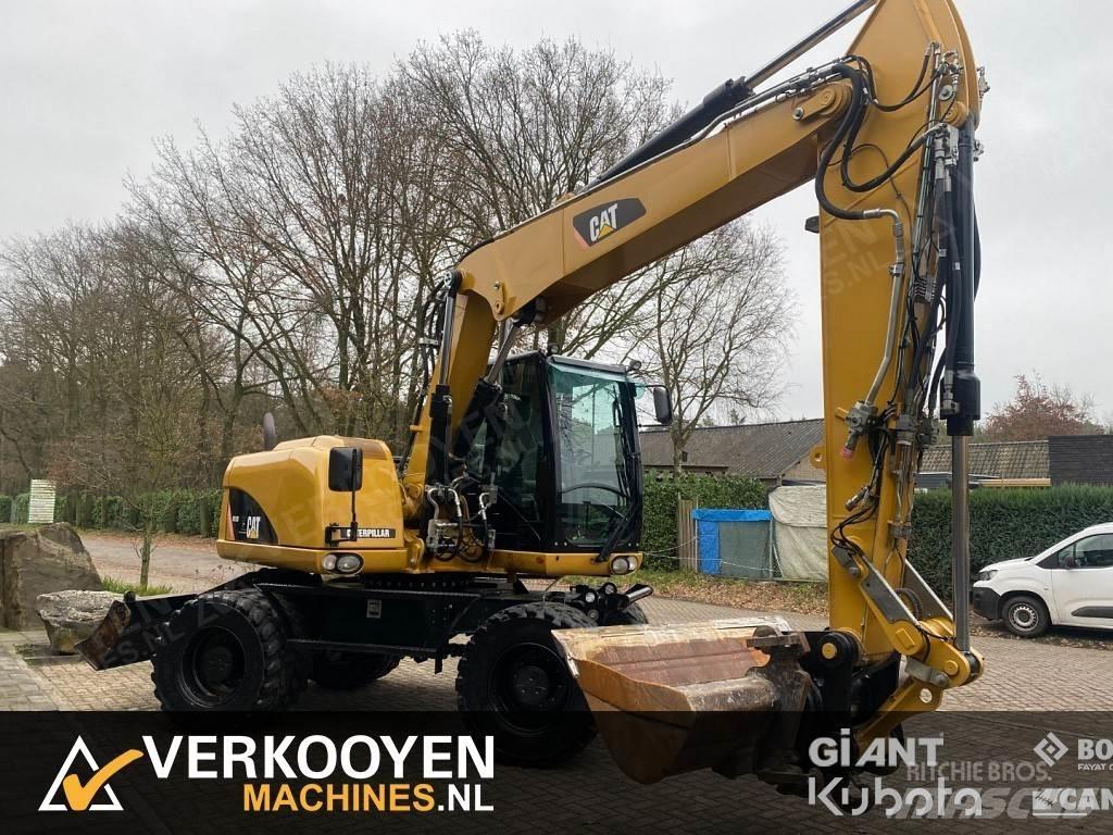 CAT M313D Gumikerekes kotrók