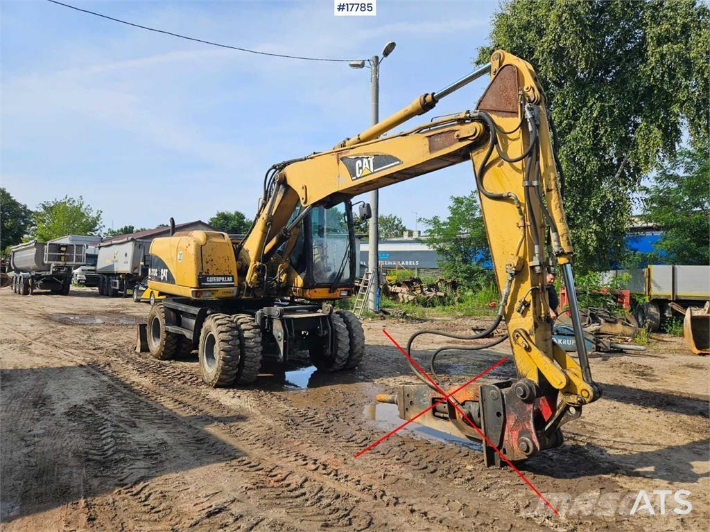 CAT M313 C Gumikerekes kotrók