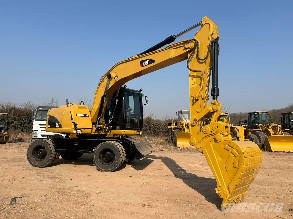 CAT M 320D Gumikerekes kotrók