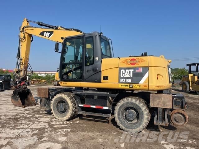 CAT M315D Gumikerekes kotrók