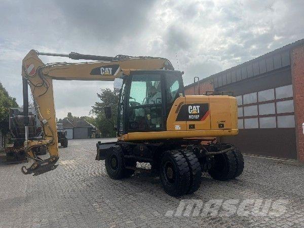 CAT M318F Gumikerekes kotrók